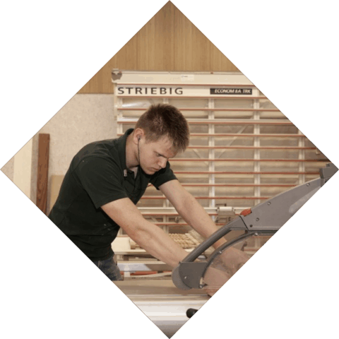 Student is in de machinale bezig met het zagen van hout