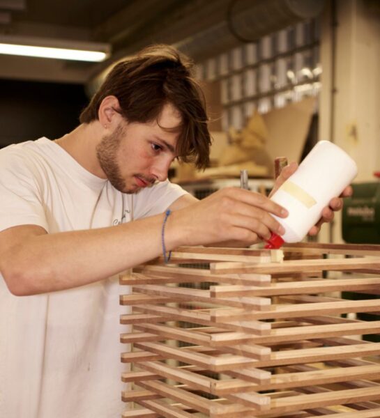 Student is hout aan elkaar aan het lijmen